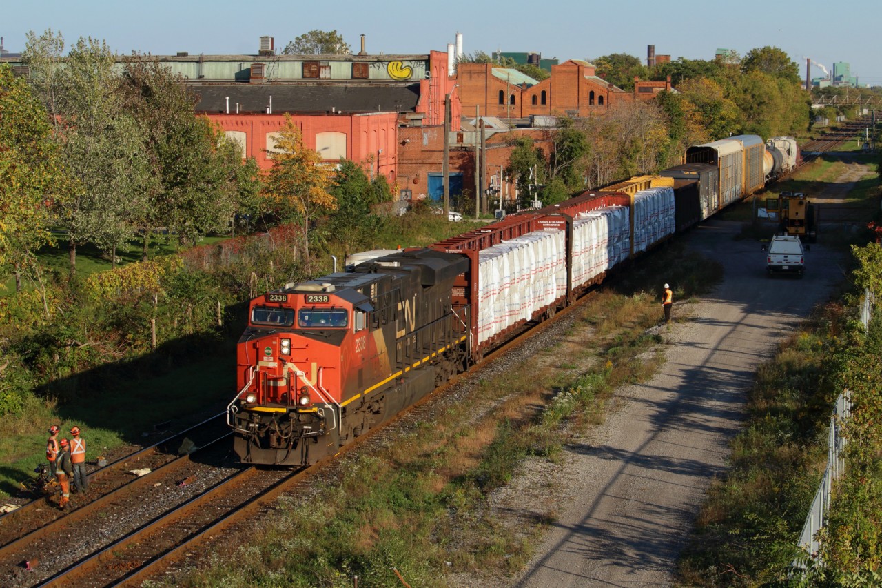 Cries of "hot rail!" filled the air as X422 approached the gang working at mile 43 of the Grimsby Sub.I had caught wind of the X422 a little less than an hour earlier, when I heard this MOW crew talking to RTC. As I waited, I was pacing impatiently on Ferguson Avenue, watching the shadows get longer and wondering if I may lose the chance at a shot I had been imagining for a few months now. A sole ES44DC brought a dozen cars from Port Rob in the late afternoon sun. It may have worked in my favour that it was a short train, as they made pretty good time from St. Catharines to Hamilton.