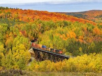 Rounding the hills of northern Quebec, CN 306 rounds the bend at crosses the trestle at Saint Eleuthere, PQ. The colors are really starting to show around here. 