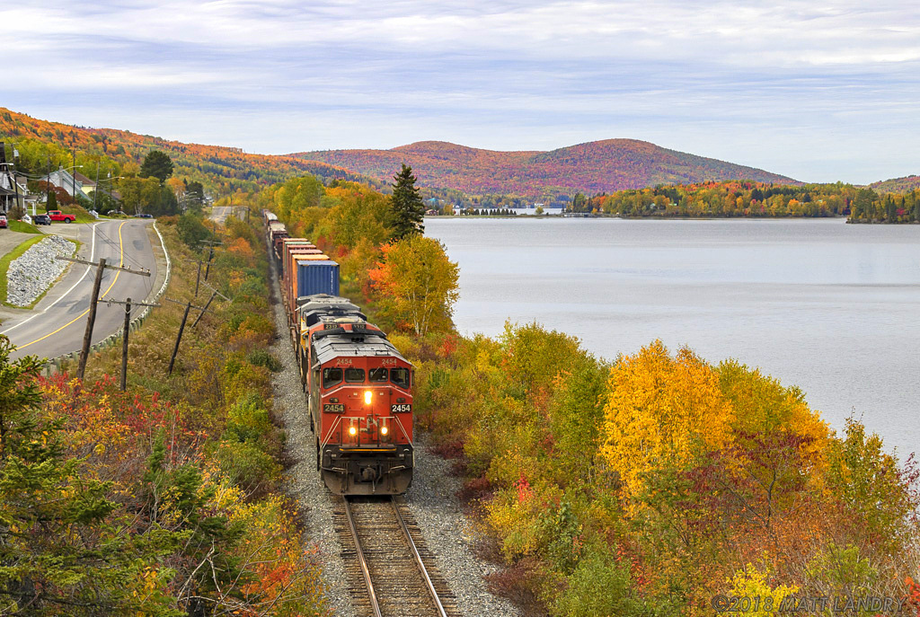 CN train 306 is eastbound, as they head through the scenic Lac Baker, shortly after crossing over from Quebec into New Brunswick. This area of New Brunswick looks great all year, especially in the Fall.