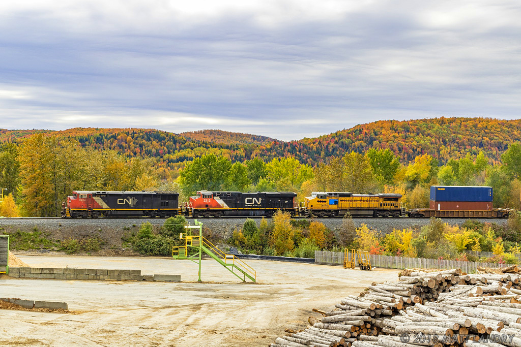 CN cowl 2454 leads train 306, as they pass the Irving Mill at Baker Brook, New Brunswick, nearing their next crew change point of Edmundston, New Brunswick.