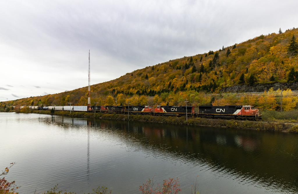 CN 5693 leads westbound train 407, as they rumble along the scenic Folly Lake, Nova Scotia in Fall colors.