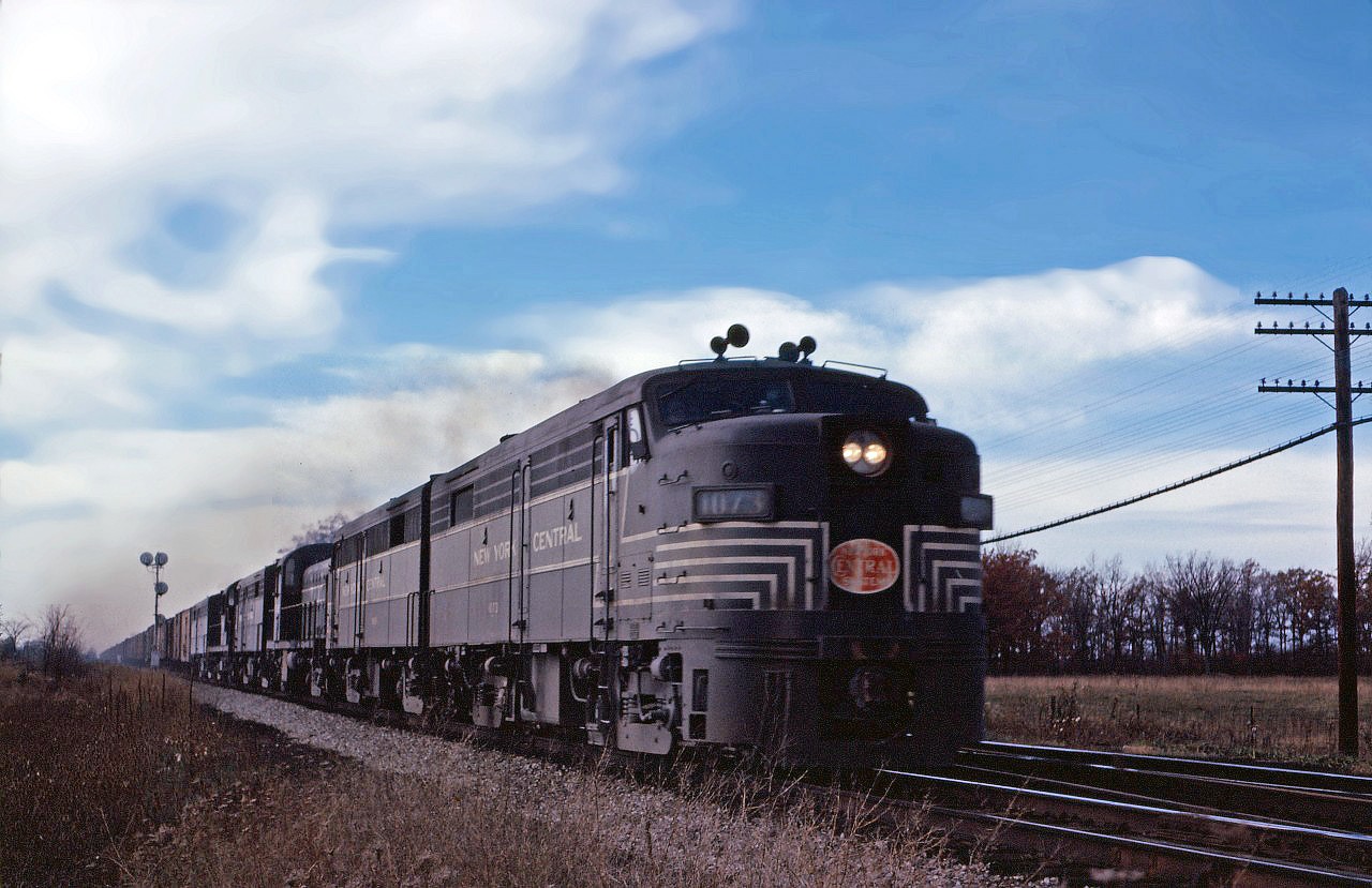 The NYC liked its Alcos, owning 44 FA-1s, 23 FB-1s, 80 FA-2s, 50 FB-2s, 23 RS-2s, 135 RS-3s but only 9 RS11s and 25 RS-32s. These engines were largely used on "Lines East" (of Cleveland) and based out of De Witt (Syracuse, NY). In the early 1960s, NYC began trading in its older Alcos for more modern power--initially the RS-32s and after 1964 on General Electric U25B, U28B, and U30B units.

In this photo, we see three FA-2s, an FB-2, an RS2 and either an RS11 or RS32 leading an eastbound through Canfield.