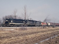 <B>Nober, where's Nober?</B>   Well, if you follow the CASO west out of Hagersville on Concession 12 Walpole, the road crossed the CASO at Nober.  A nice clean NYC U28B, a GP40 and a GP35, followed up with a CB&Q Burlington Route U28B are heading westbound toward Waterford on the CASO. What's that brown car in the field?  Well, that's my 1961 Corvair parked on a laneway.  We didn't have time to close the doors as we ran accross the muddy field to grab this shot.  