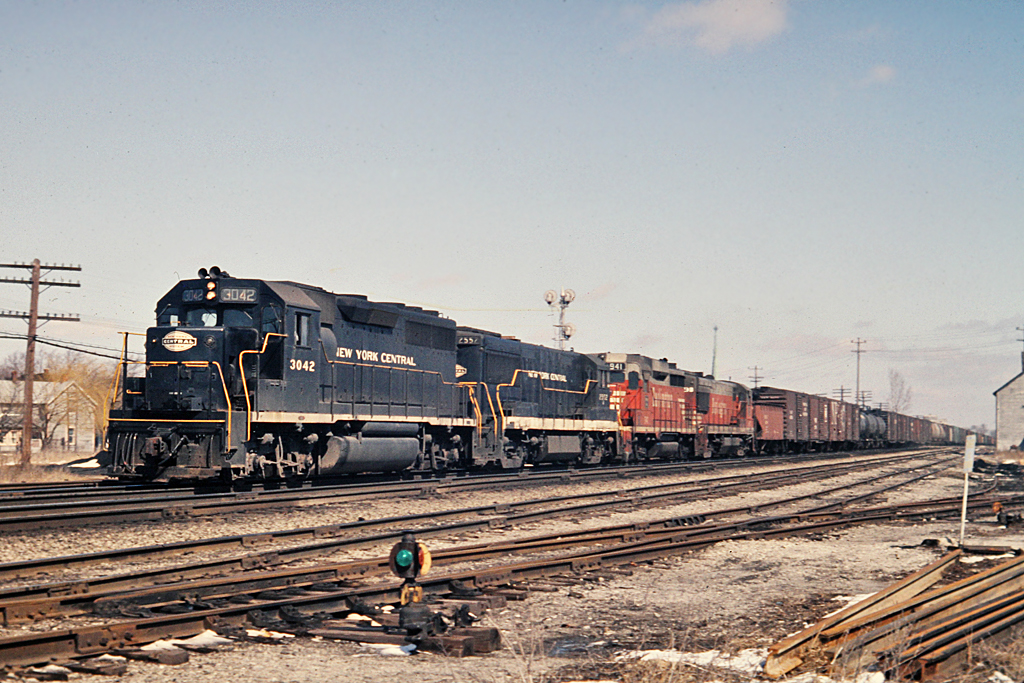 More from the heydays on the CASO in Southern Ontario.  A few traces of snow signify that winter has not completely gone yet. A pair of Burlington units are in the consist and one is the 941, somewhat captive in Canada as per Bruce Mercer.   I find it interesting that many of my shots on the CASO, be it NYC or C&O, have a GE and a GM unit.  Here we have a GM GP40 3042 and GE U25B 2557 as the GM/GE combo.