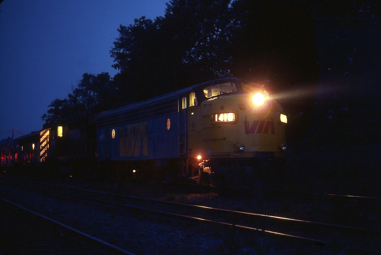 I often wondered how they did it. Five hours late getting to Parry Sound from Toronto. It doesn't even TAKE five hours to get to Parry Sound. But once again, and I saw this quite a few times, the train was very late. Due in at 1800; this image was taken somewhere after 2300 and again the train was having problems. Middle unit...so they had a 'time out' at the Parry CP station. I do not recall any passengers waiting. So I went out for a photo as I was at the station for 1800 and the agent and I shared pizza so the time went by nicely. The plan now was a night shot via tripod but somehow I got all wrapped up in yakking and forgot the mosquitoes were ferocious once the sun went down. So this image is a very careful hand held effort. Power is x-CP 1416, CP 8563 (RS-10) and x-CP 1422. The RS-10, ret'd by 1983, was sandwiched by a pair of FP7As, the leader ret'd by 1983 and the trailing unit became VIA 6566 in 1980. Around the headlight, that is not scarring or neg defects you see....that is the swarm of bugs, and they were everywhere!!!