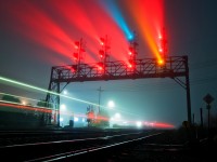Heavy fog has blanketed much of the Greater Toronto Hamilton Area for the night, as GO Equipment 700 is seen zipping past the controlled signals at Oakville Yard heading for Aldershot to start the morning. Meanwhile Rail Traffic Controller Ashley Blokzyl on the YO Desk in Toronto lines up another westbound equipment move on track one. 
