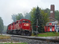 At Guelph Line in Campbellville, a station once sat here. See this sequence by <a href=http://railpictures.ca/author/wmthomson target=_blank>Bill Thomson</a> from 1964 of the last Train 21 on the Galt subdivision at Campbellvile <a href=http://www.railpictures.ca/?attachment_id=25072 target=_blank>here</a> to give you an idea of what it looked like. Funny how a place manages to hold onto its heritage. The station may be gone, and the area is all grown in, but a Caboose is shown in the photo as a homage to the continuing railway heritage of the area. I know I did this shot back in May with ago with <a href=http://www.railpictures.ca/?attachment_id=33429 target=_blank>DH 7303</a> but this rail train was another fitting subject on a very dark, very cold day in late Summer.