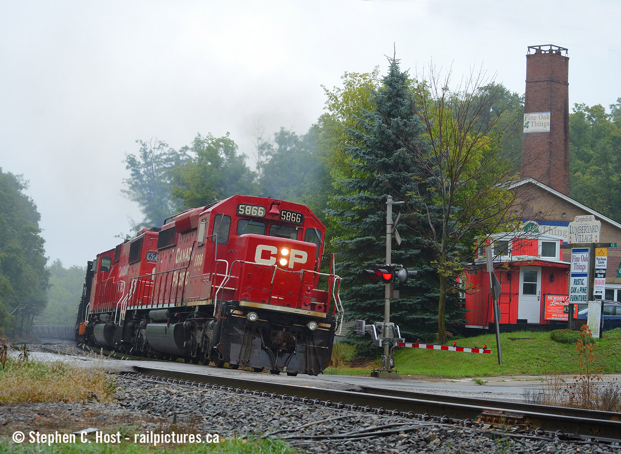 At Guelph Line in Campbellville, a station once sat here. See this sequence from 1964 of the last Train 21 on the Galt subdivision at Campbellvile here to give you an idea of what it looked like. Funny how a place manages to hold onto its heritage. The station may be gone, and the area is all grown in, but a Caboose is shown in the photo as a homage to the continuing railway heritage of the area. I know I did this shot back in May with ago with DH 7303 but this rail train was another fitting subject on a very dark, very cold day in late Summer.