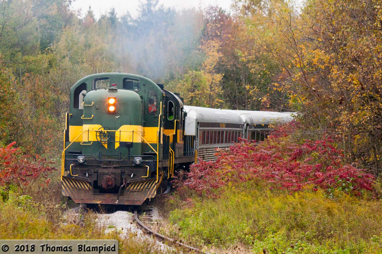 The colours at Cedar Curve on the York-Durham Heritage Railway are changing as a pair of ALCO/MLW units shatter the silence of a quiet Thanksgiving Sunday. With an extra-long consist to accommodate the extra passengers enjoying the fall colours, YDHR 22 and 3612 were both put into service pushing the train towards Stouffville. This operation was very resource-intensive, needing three running crews. The first crew is up in the cab car, the second in 3612 and the third in 22. This was old-school MUing, with radio instructions relayed between the two locomotives as the crews manually notched up and down in tandem.
