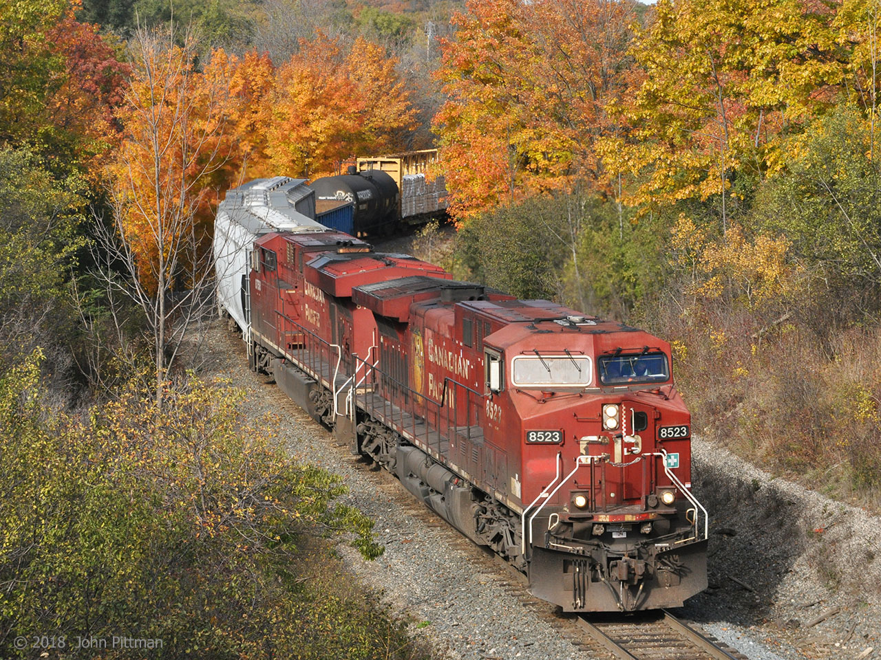 CP 8523 (AC4400) and CP 8758 (ES44ac) lead the second Hamilton Sub southbound of the afternoon out of the autumn woods. They are approaching the underpasses below Plains Road and Ontario Highway 6. The train crossed into Burlington just south of Waterdown, continuing the curving descent of the Niagara escarpment.
