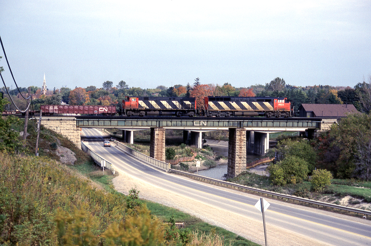 CN 9903 and CN 2522 cross a bridge in Pickering, Ontario on October 12, 1986.