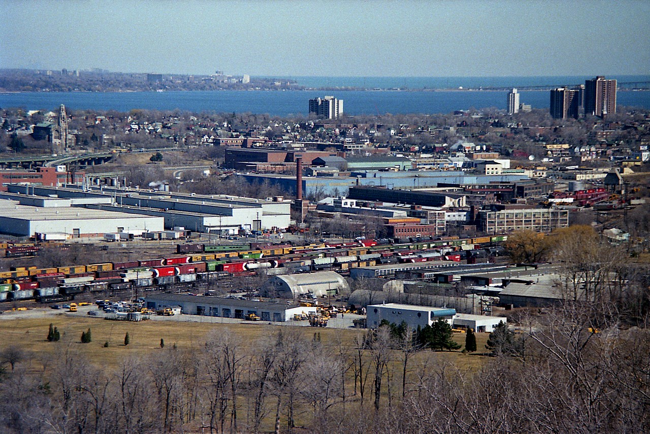 Although this image was taken 3 months after the TH&B was incorporated into the CP, it was still TH&B to me. This overview of the Aberdeen Yard is interesting. For viewers not local, that is Aldershot in the distance on the other side of Hamilton Harbour. On the left is the Cathedral Basilica of Christ the King, a noted landmark; and that is King St (Hwy 8) running east/west in front. The ramp is to Hwy 403. In the foreground,the old Aberdeen Yard looks full. Of note is that green coach car...I was not aware of it back then.(reporting mark??) The old yard is 'dead-ended' now; the track used to continue to Brantford until a washout doomed the line back in 1990. On the right side in the image is the old TH&B shop buildings, the roundhouse, turntable and some CP power. These buildings were razed in early 1992.