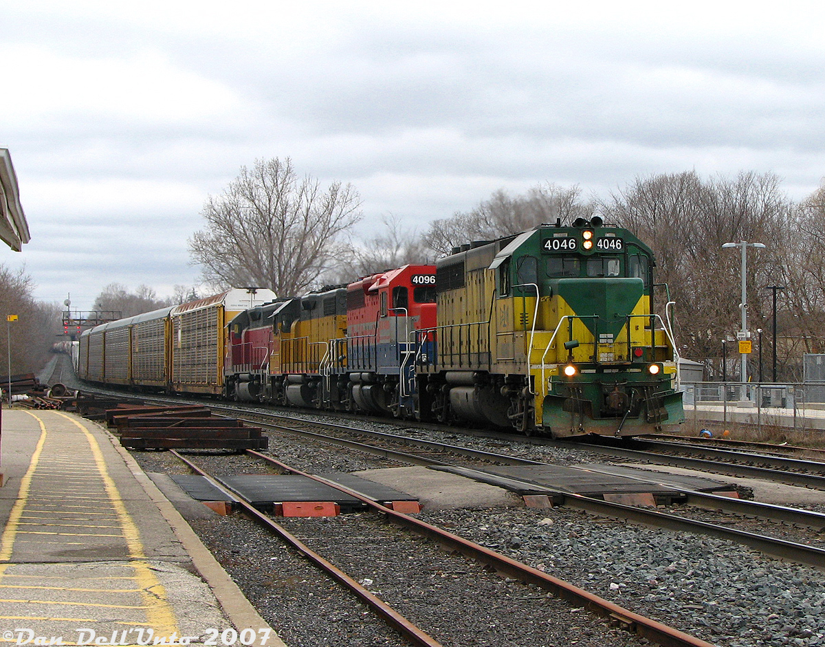 Another one from GEXR's "Rainbow Era" of power: GEXR #432 slowly rolls through Georgetown past the station as it comes off the Guelph Sub and proceeds east on the Halton Sub bound for CN's MacMillan Yard. Not one unit here matches, but that was typical of the mix of 4-motors that showed up: GEXR GP40 4046 (ex-Virginia Southern, originally built for the MKT), RLK GP40 4096 (a former CN 9300-series unit), LLPX 2236 (an ex-Long Island RR GP38-2 once used in commuter service) and GEXR GP40 4019 (originally built as a hi-nose N&W unit). No matching G&W orange in sight for a few more years!