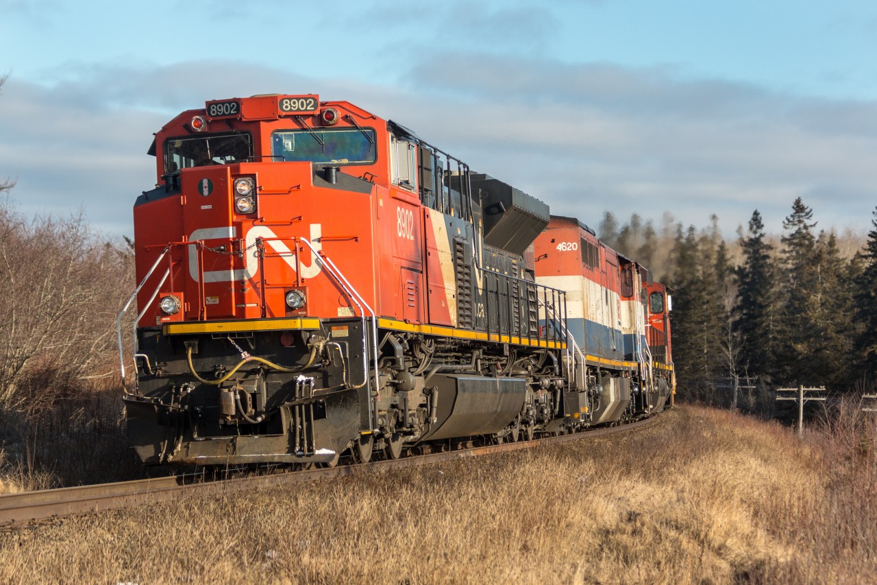 CN 8902 (EMD SD70M-2)with help from BCOL 4620 (GE C40-8M),CN 2618 (GE C44-9W) leads Q120 around a curve at Mackay’s siding heading west to CN’s Rockingham yard
