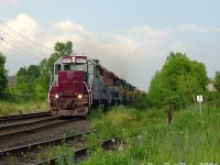<b><i>Mad Dash for the Guelph Sub:</i></b> GEXR #431 with the usual cast-off rag-tag fleet of 4-motors races VIA #87 westbound on CN's Halton Sub, both heading to Georgetown where they will enter home rails on the GEXR-controlled Guelph Sub. Where is VIA #87 you ask? Why, coming up just behind 431's power! (the photographer got skunked for the side-by-side shot by seconds).
<br><br>
Rewind a few minutes earlier: in the heat of the evening GO rush, VIA #87 put in its usual appearance after GO #209 and made its station stop at Brampton around 6:10pm (on the north track, as no south platform yet). The CN RTC then managed to squeeze in GEXR #431 through the single track gauntlet between Peel and Brampton East and onto the south track. #87 finished its station stop and had just departed Brampton Station, getting up to speed as 431 rumbled by the Dixie Cup Spur where we were waiting. In moments 87 would overtake 431 and make the sprint to the single-track Credit River bridge and make its quick station stop at Georgetown, with 431 following behind. I can only assume the RTC told 431 "no rush" and got 87 onto the Guelph Sub ahead of him at Silver. Since this was pre-Guelph/Kitchener GO expansion, neither would have to content with any GO trains after Georgetown.
<br><br>
The rag-tag consist of the day was CEFX 6537, RLK 4096, LLPX 2210 & GEXR 4046. The famed tunnel motor 3054/9392 wasn't the only worn-out SP cast-off in the fleet, as GP38-3 leader 6537 started out life as an SP GP35. This was the only time I ever caught it in service, as not too long after it became a deadline queen and served as a parts unit for years until GEXR had to return it to the leaser (they put humpty-dumpty back together again and sent it on its way, and it was then forwarded to CAD for repainting/rebuilding. At last check it was running around the CMQ in blue CIT paint).