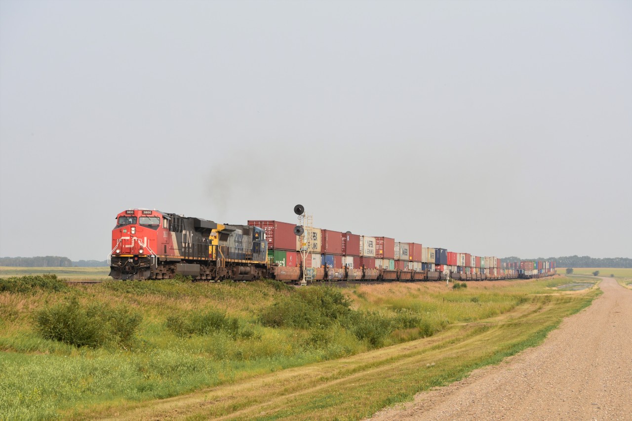 Out in the land of no cell service and nothing but quiet CN 3800 disturbs the peace with exx. CR ex. CSX YN2 GECX dash 8 heading Westward with an intermodal. Sitting in the siding is a Eastbound intermodal waiting for the westward traffic to clear out of Saskatoon.