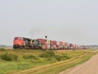 Out in the land of no cell service and nothing but quiet CN 3800 disturbs the peace with exx. CR ex. CSX YN2 GECX dash 8 heading Westward with an intermodal. Sitting in the siding is a Eastbound intermodal waiting for the westward traffic to clear out of Saskatoon. 
