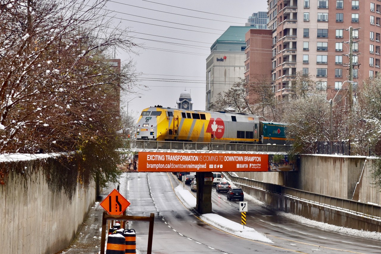 After picking up a handful of passengers moments ago at the station, VIA 84 is now leaving Downtown Brampton as it continues on towards Toronto. They are passing over the Queen st overpass and lead unit was a wrapped P42 as VIA continues to celebrate their 40th anniversary in year 2018. As years end approaches, word has it that VIA plans to get a new paint scheme once the wraps come off. It’ll be interesting to see what they come up with!  Time: 10:57