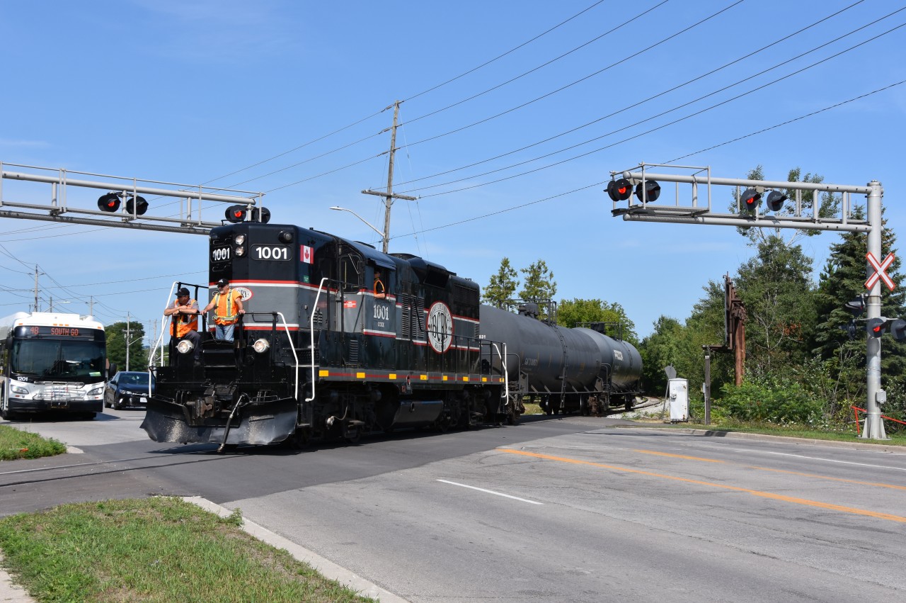 With a pair of crew members riding on the nose (one being former OBRY operatior Steve Bradley who has since been promoted to BCRY after Cando handed the Owen Sub operations over to Trillium) CCGX 1001 makes its way across Young st in Barrie with a pair of tank cars destined to Comet Chemicals Ltd at the end of the line in Innisful.