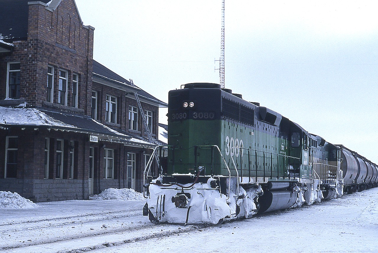 Gads!!  Nippy !!!  No doubt the severity of winter in SW Ontario, notably nasty around the Stratford area, played havoc with the fledgling GEXR operations. I'm assuming this BN 3080 was 'on loan' to help the railroad get thru the winter, as they were only running with 4 GP9s back in these early days. I still remember this day vividly, and it was a lot more bitter than it looks. The second unit is GEXR 177.
