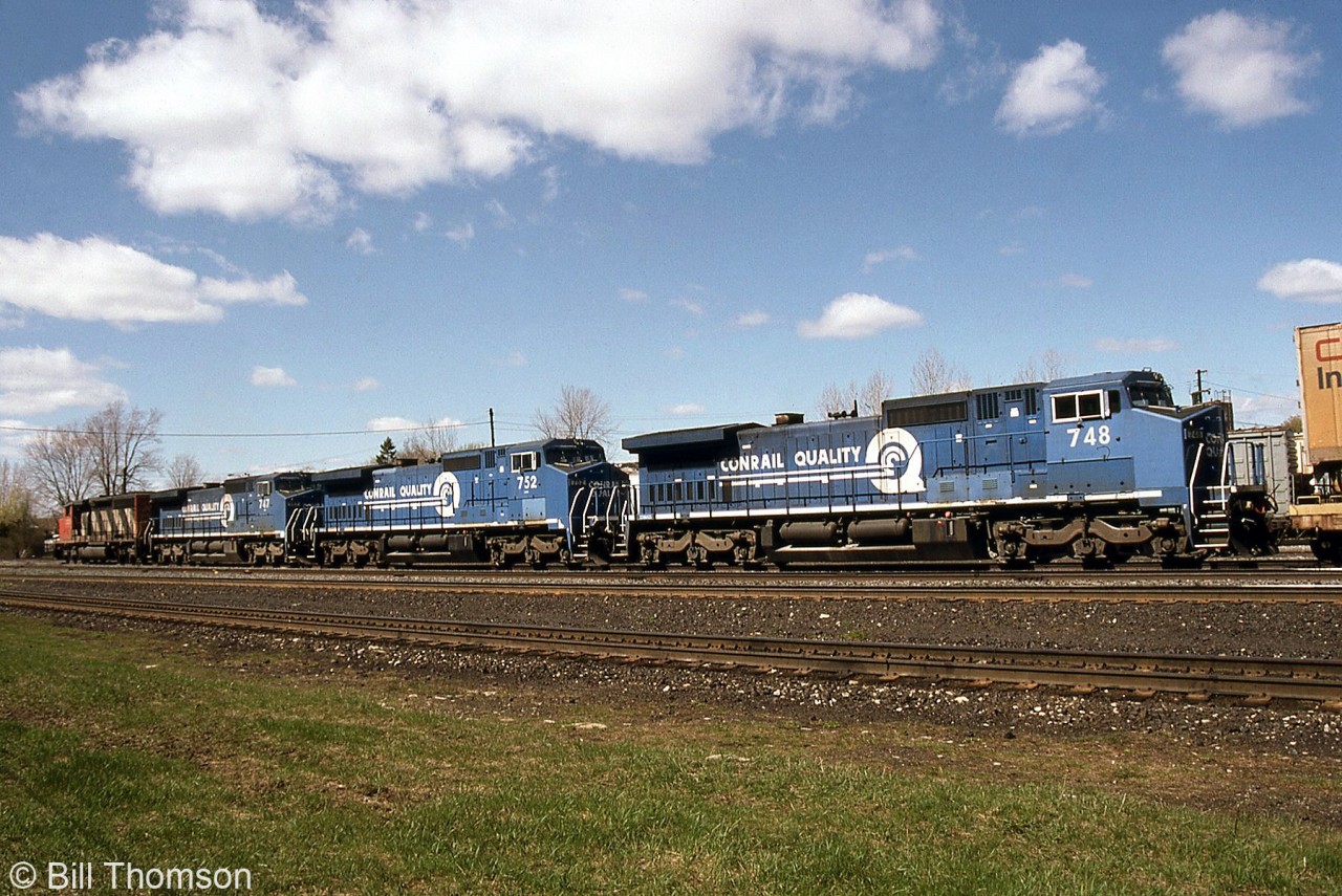 Another view of a detouring CN train (pictured before here) on CP at Smiths Falls, pulling ahead and showing off the trailing Conrail C40-8W units 748, 752 and 747 behind CN 5335.

The three blue units were part of 60 C40-8W units purchased by Conrail for leasing service with LMS (GE), with many on a shared lease between CR and CN. Unlike some of the units painted blue but lettered LMS, these later units were numbered and painted in the CR livery. When the Conrail split happened, the leasers were divided up between CN, CSX, and NS.