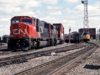 Another one of the CN freights detouring over CP: CN SD75I 5651 and SD70I 5609 lead a westbound on CP's Belleville Sub, as VIA trains 42 and 43 make their stops at the platform by the station.