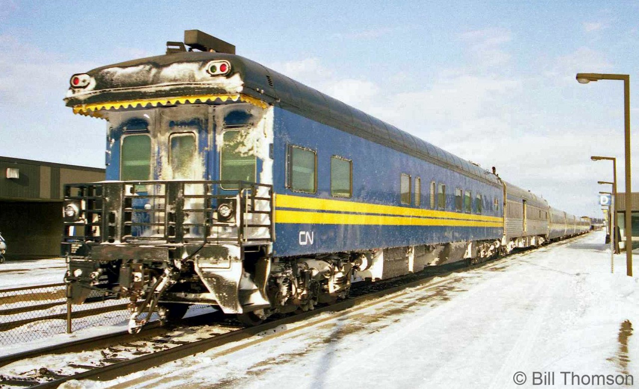 One of CN's business cars (possibly CN car 94) trails on VIA #64 at Kingston station in 1992. CN painted their business/official and track inspection cars in the same blue/yellow paint as VIA's ex-CN equipment, but with CN logos instead of VIA.