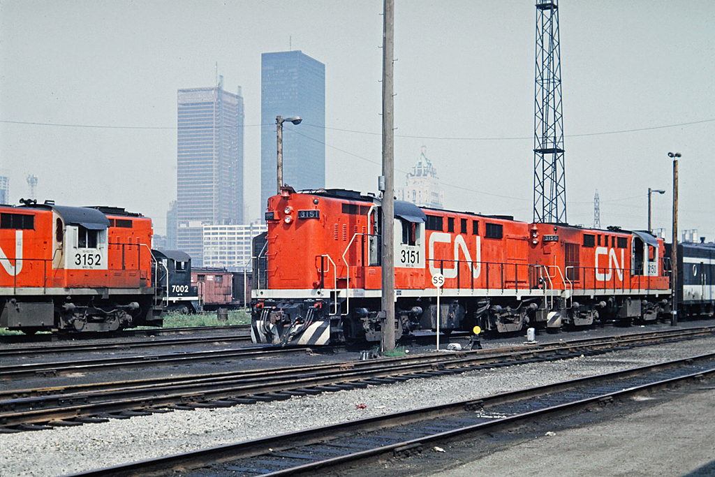 Half of the Tempo units are at Spadina in this 1968 view.  A total of six RS-18's were rebuilt for Tempo service and equipped with HEP.  Hawker-Siddley built 25 cars for the Tempo service. CN ran 4 trains per day from Toronto to Windsor and one train per day from Toronto to Sarnia.  When CN rebuilt these units, they were painted in the green and gold scheme and operated in regular service for some time before being repainted into Tempo colours.  To see an example of a Tempo before Tempo,  see this picture of CN 3887.