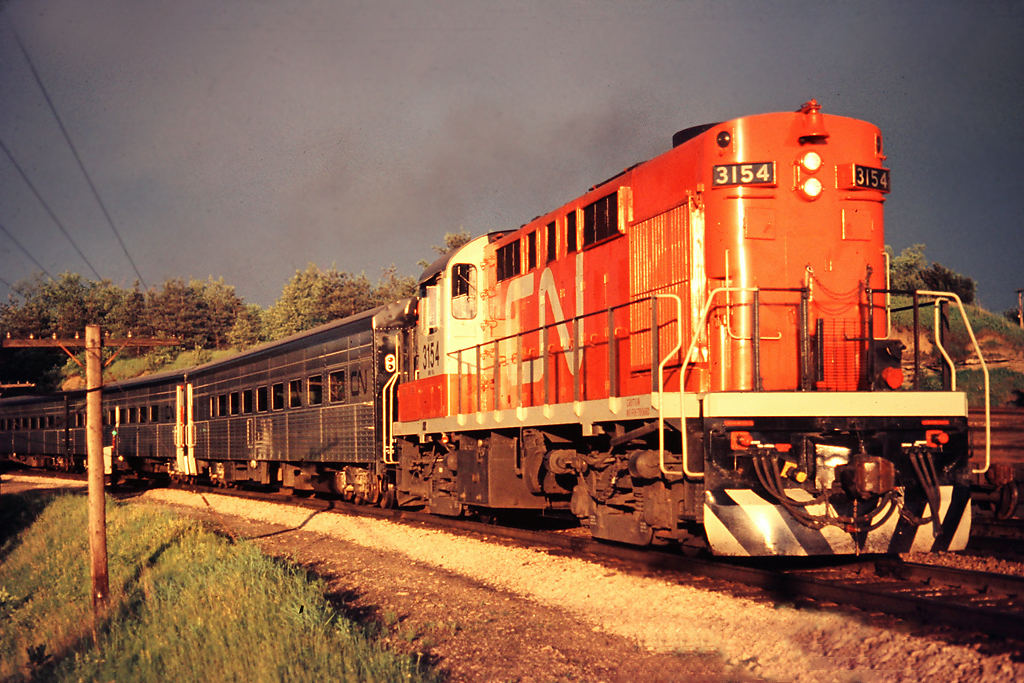 A thunderstorm had just passed by when the sky cleared enough to get the setting sun to light up a Tempo Train led by CN 3154 at Hamilton West.