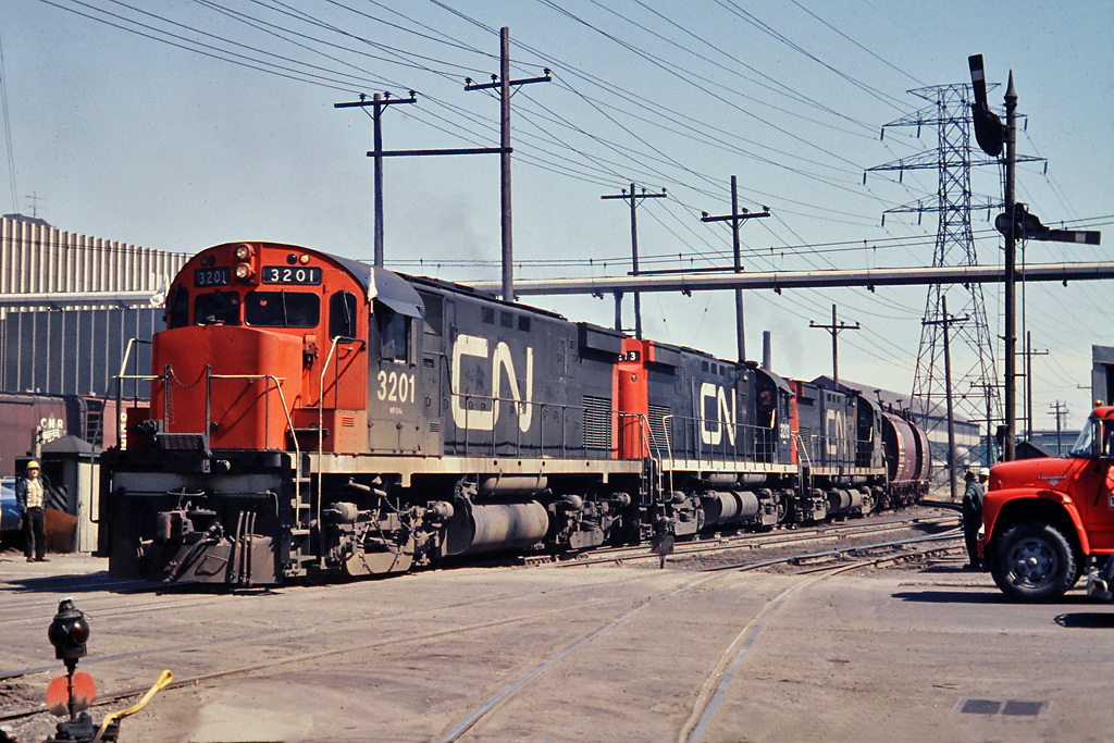 Sequence 4 of 4  As the train worked it's way into the the plant, the head end power backs across Ottawa St.  That wonderful semaphore signal is long gone but the Dofacso head office building (now Arcelor Mittal) with the vertical column exterior decor still stands.
