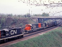<b> Old meets new. </b>  It is spring of 1968 and CN 4593 west meets SD-40's CN 5047-5046 east at the Plains Rd. bridge.  Looks like auto parts on the head end possibly destined for Ford in Oakville.  