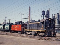 <B>Sequence 3 of 4</B>   CN 8167 has been tacked onto the tail end of the Dofasco ore train at Ottawa St. on the N&NW Spur.  It will pilot the train in a reverse move into the Dofasco plant where the loaded cars will be set off and another unit train of empties will be picked up for return to the mine. 
