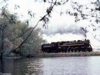 CN Northern 6218 passes through the light rain with an excursion train, as viewed from across a pond at Brunner (located along the CN Newton Sub south of Milverton and north of Stratford).