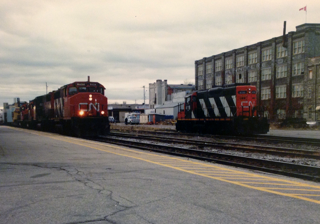 On November 4, 1998 my Dad and I stood on the station platform during a late fall afternoon and watched as CN 432 rolled into Kitchener from London with a consist typical of the time period. It included; GP40-2L(W)’s 9454, 9590 and GP9RM’s 4115 and 7020. We knew that in a couple of short weeks the CN trains on the line would become a part of history, as the Guelph Subdivision would be taken-over by the Goderich-Exeter Railway (GEXR) which was expanding and handling all the freight traffic on the line and the related spurs. This transition was just one part of an almost shortline revolution across Ontario as several shortlines would commence operations on lines sold or leased from CN and CP during the late 90’s. However, that was then. Now in 2018, just as CN took back the Hagersville Subdivision from the Southern Ontario Railway in September, CN is on the verge of regaining control of the Guelph Subdivision from GEXR on November 16. 
GEXR had originally begun leasing the Guelph Subdivision from CN for 20 years being operated under RailTex at the time. With the lease coming to an end and CN and current owners G&W not coming to an agreement to purchase or further extend the lease, CN had announced to the effected customers earlier in the year that they would be returning as the operators. GEXR will still operate the Goderich Subdivision between Stratford and Goderich as well as the Exeter Subdivision from Clinton to Exeter. Reportedly, GEXR will retain only QGRY GP38-2 2008, GEXR GP38-3 2073 and RLHH GP38-2 2117 for use on their scaled down operations. 
As for new CN train assignments, as of November 7, the following has been confirmed by CN sources as the operating plan, which is still subject to last minute changes and adjustments. 
CN A431, will be scheduled 7 days per week, Kitchener Turn, ordered 21:00 out of Mac Yard.
All assigned jobs will have the “L” designation and are as follows:
CN L540 (formerly 580), ordered 0:700 from Kitchener, 7 days per week- To service Guelph with Acton scheduled on Tuesday/Thursday- To service Kitchener and the Huron Park Spur-Including the interchange with CP at Kitchener 
CN L568 (formerly 516) ordered 09:30 from Kitchener, Monday-Friday, Stratford or St. Mary’s Turn operating St. Marys/Kelly’s/Thorndale-Tuesday/Thursday and Stratford other days
CN L566 (formerly 584) ordered 21:00 from Kitchener, Monday-Friday to service Waterloo Spur and Elmira
CN L542 (formerly 582) ordered 07:30 from Guelph, Monday-Friday to service Guelph/Fergus Spur/Cambridge
During September, CN began constructing a new operations centre in the Kitchener yard, which will be where the crews are based. As of early November the new building was seemingly complete having been assembled with modular sections and was 3600 square feet in length complete with newly constructed wooden ramps. It is situated near the old wye in the yard and according to sources; CN will base the power for the local assignments by this new building. CN will now interchange traffic with GEXR at Stratford as previously done 20 years ago with GEXR motive power still laying over in Stratford yard between assignments as CN will still retain ownership of the yard. The transition from GEXR to CN will no doubt be well documented so please stay tuned as all the latest sightings will be photographed as two decades later CN makes their return to the Guelph Subdivision.