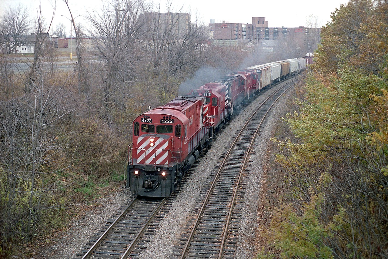 Even the Niagara Falls 'locals' will have to stop and think in regards to just where this shot was taken of a CP westbound which has just cleared the USA, rolling thru Clifton Hill and is on the way to Toronto.  I am standing on the roadway bridge to the Skylon Tower. That is 'tower parking' on the left of the picture. The expansion of the Tourist Trap Towers around this area of the city in the past 30 years has been nothing short of remarkable. Pity it was at the expense of the railroad. It is no longer; having been removed in the early 2000s. CP 4222, 8212, 4245 and 8208 is the power.