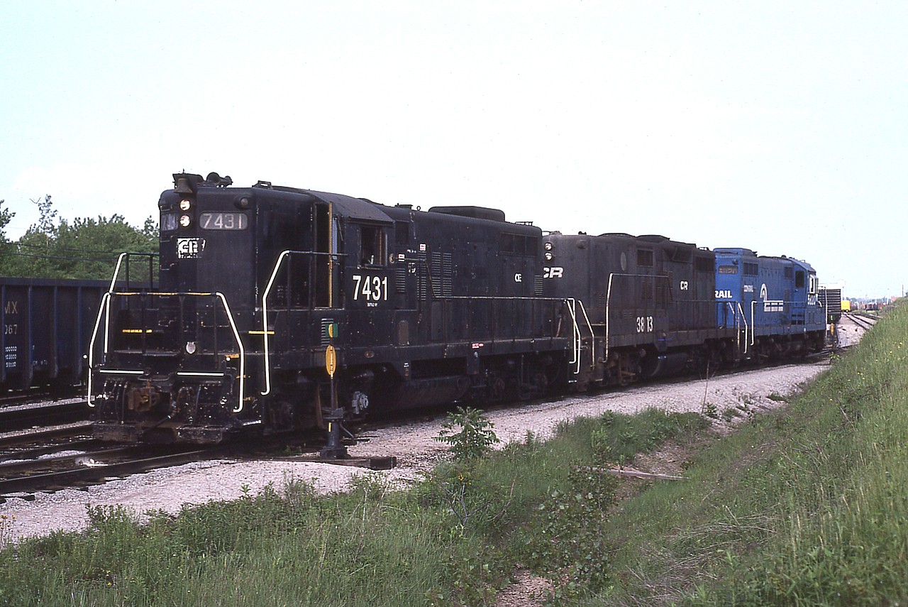One thing about hanging around in Fort Erie between the International Bridge and as far west as 'Duff' back in the late 70s and early 80s where the yard becomes the single track westward was you just never know what power you might see roaming around. Transfers from the States utilized whatever was available, it seemed. In this case it is CR 7431, 3813 and 5820. Note that the middle unit is cabless (GP9B) These units were seen, but rather infrequently. In this image, the trio has dropped off tonnage for Canada, and will return stateside with CR 5820 on the lead after it picks up US-bound traffic.