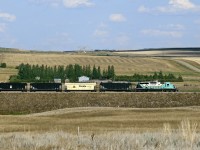 Having just loaded coal at the mine, Luscar Coal's shuttle heads south over a five mile line to the Saskatchewan Power Co. station just east of Coronach in the Poplar River Valley 