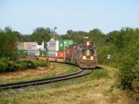 An Illinois Central SD70 locomotive leads CN train Q120 from Toronto, ON to Halifax, NS through the University town of Sackville, NB.
