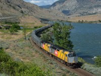 VIA 1, the <i>Canadian</i>, is led by two VIA 40th Anniversary-wrapped units, as it rolls west along the bank of the Thompson River near Martel.