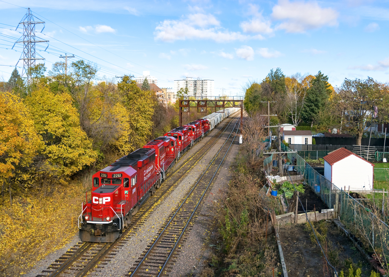 A five-pack of GP20C-ECO's (CP 2261, CP 2318, 2262, CP 2307 & CP 2304) leads a long CP F94 past North Jct, the train consisting mostly cement hoppers for the Lafarge plant in St-Mathieu.