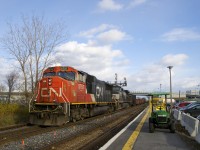 CN X321 with CN 5757 & NS 9737 for power is passing a baggage cart at Dorval Station with a short train consisting mostly of gondola's. They will lift more cars further west at Coteau, before continuing towards Toronto.