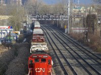 With congestion ahead at Taschereau Yard, a very long CN 527 with CN 2030 leading is cooling its heels on the transfer track of CN's Montreal Sub.