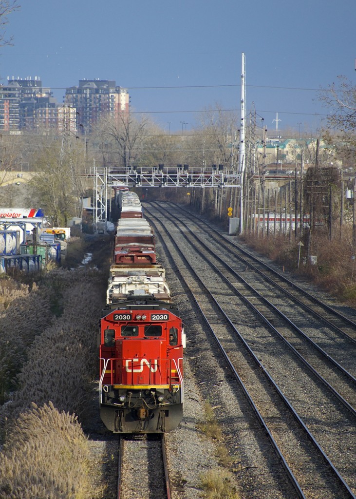 With congestion ahead at Taschereau Yard, a very long CN 527 with CN 2030 leading is cooling its heels on the transfer track of CN's Montreal Sub.