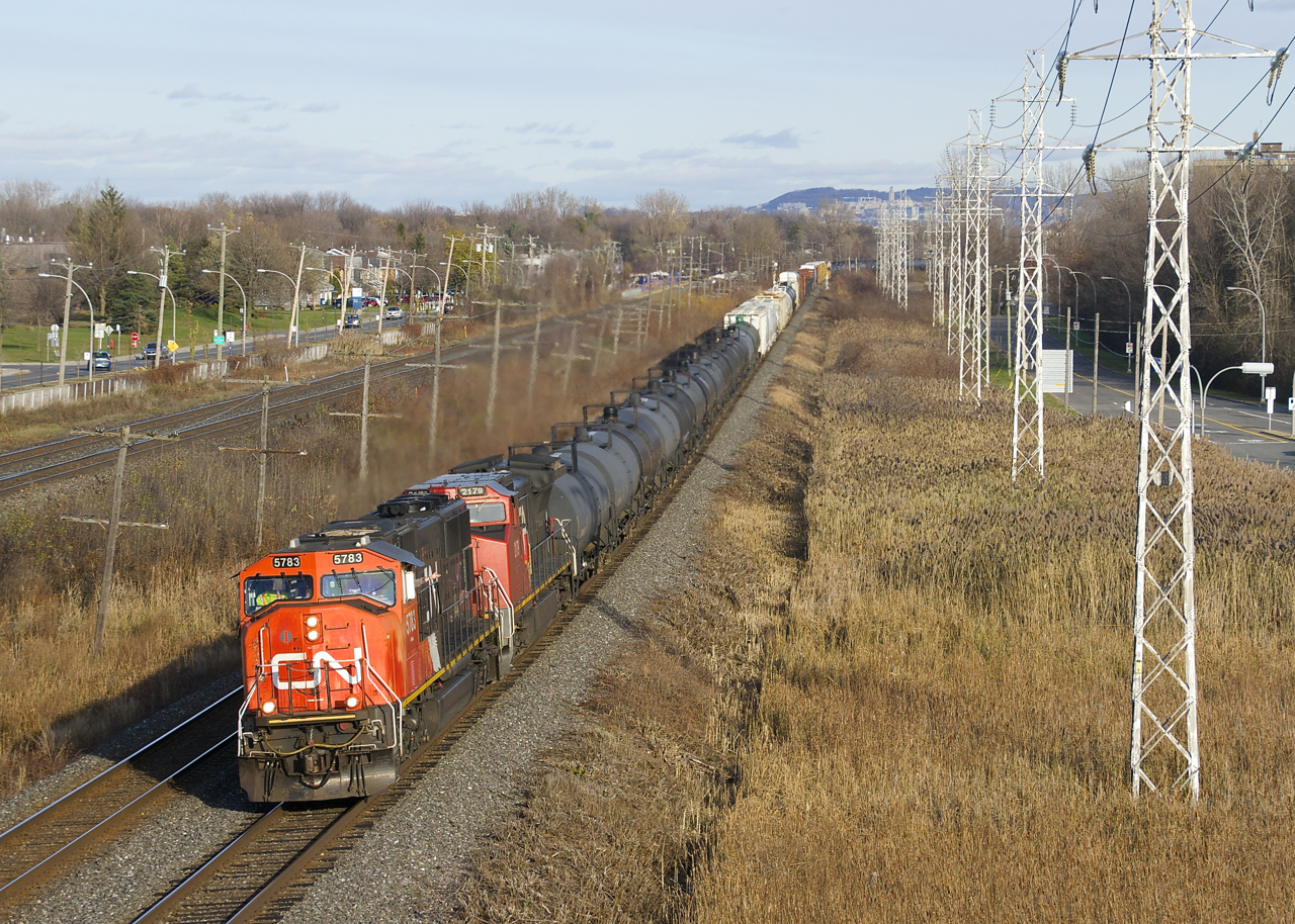 CN 5783 & CN 2179 lead a 130-car CN 377 which is approaching MP 14 of the Kingston Sub, as the conductor waves from the lead unit.