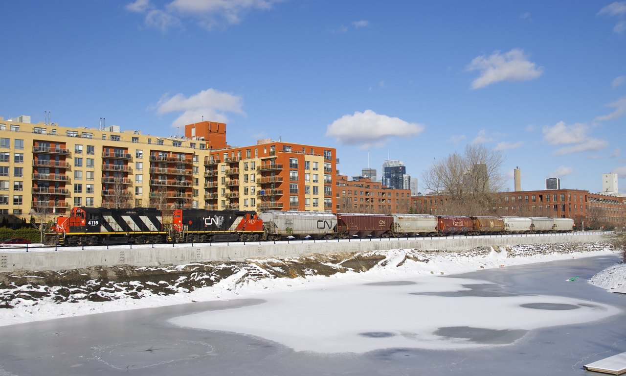 After being closed since this past spring due to extensive work on the Lachine Canal's retaining walls, the East Side Canal Bank Spur reopened last week. Here CN 4115 & CN 9677 shove 8 grain cars to Ardent Mill, the only client on this line.