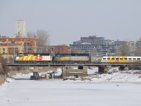 VIA 35 with wrapped VIA 6416 and unwrapped VIA 6414 for power crosses the Lachine Canal, with a wrapped LRC car first out.