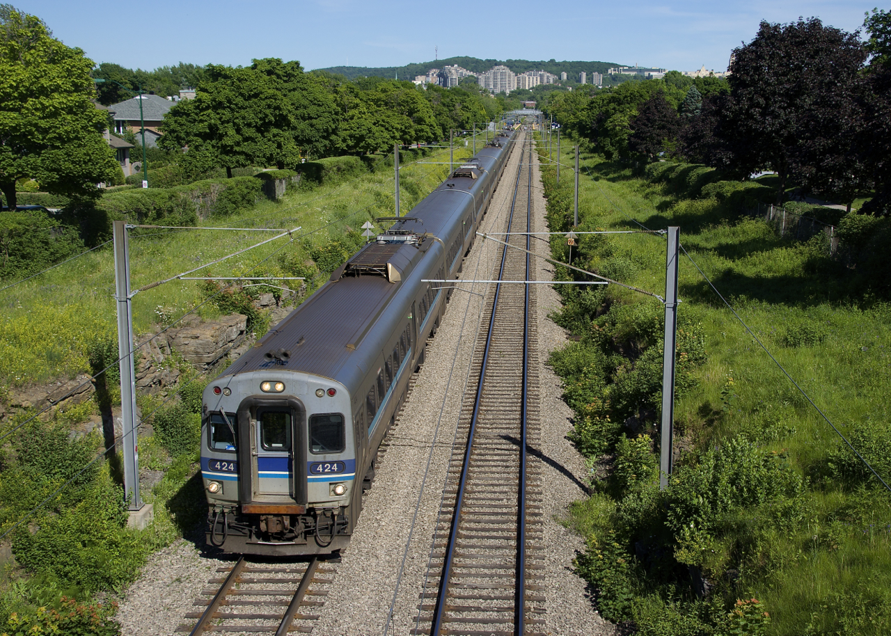 When this picture was taken this past June, this busy and electrified commuter line was double-tracked on this section of the Deux-Montagnes Sub. Within a few days one track would be taken out of service because work was starting on the REM light rail project, which will unfortunately replace this heavy rail line. Here RTM 943 is bringing commuters home and has just left Mont-Royal Station.