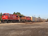 It's hard to imagine this location at the end of Court Street as the old CP station site in Milton. Up until a few years ago the old crumbling concrete unloading ramp sat overgrown in the foreground, The handsome old brick station unfortunately was razed years ago, although the towns original Credit Valley Railroad and hamilton & Northwestern stations still survive, no longer track side or in railway use. Today CP has no customers in town although up to the last decade or so a since torn down industry to the right of me occasionally received boxcar loads. How time changes so much. Here we find rack train 147 hustling past the old station site with freshly overhauled 8001, leading BNSF 5001 and former SOO SD60 6223 on a sunny fall day. 