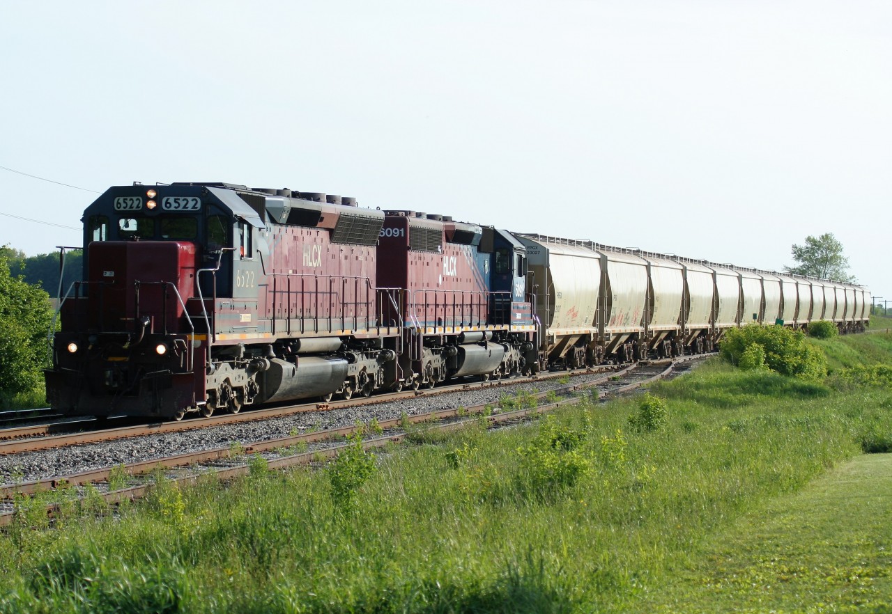 During the era of Goderich-Exeter Railway train 432 departing Stratford in the evening hours, the lighting would actually cooperate in certain locations along the Guelph Subdivision through the longer days of summer. Eastbound 432 is seen at Baden powered by HLCX SD40M-3 6522 and HLCX SD40-2CLC 6091 as they lead 15 hoppers to Kitchener where they will no doubt lift more cars destined for CN's MacMillan yard in Toronto.