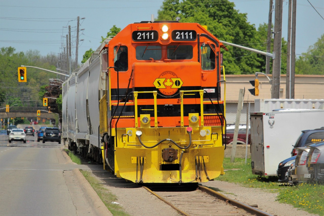 We'd chased an X597 north from Garnet to Brantford already this day (seen  here) and were on our way to Paris to meet up with it there when we picked up 2111 on the scanner. Figuring out pretty quickly what that meant, we turned around and went back to Brantford. We were coming down Colborne heading for Clarence when we saw hoppers shoving through the intersection. With no time to spare, this one is actually shot out of the passenger window of my friend's pickup truck.